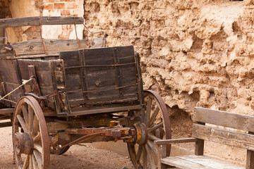 Vintage western horse cart dusty mud brick wall