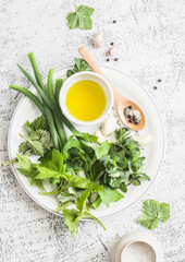 Garden herbs, spices and olive oil on a light table. Kitchen still life. Ingredients for cooking. Top view, flat lay