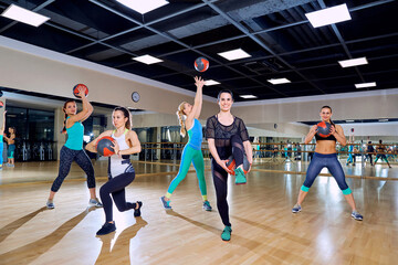 Group of women in training in the gym.