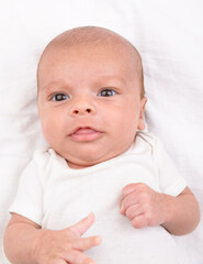 Newborn baby on white sheet