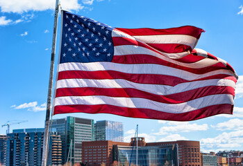 Boston waterfront and skyline and United States national flag MA
