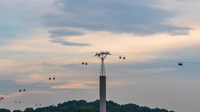 Cable Cars Singapore connected to Sentosa Island with a beautiful sunset cloudy sky
