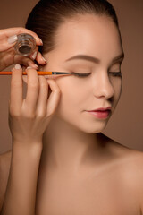 Obraz premium Beautiful female eyes with make-up and brush