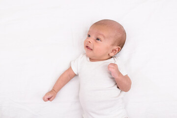 Newborn baby on white sheet