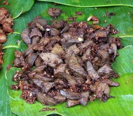 Fried pork liver on banana leaf.