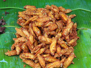 fried chicken wings on banana leaf.