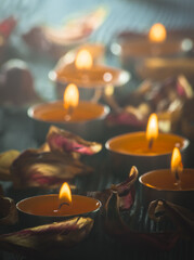 yellow candles and plamennoi surrounded by dry petals of tulips