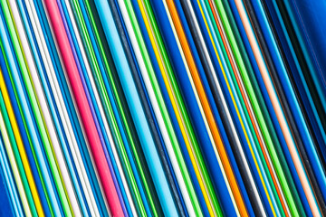 Multicolored pipes. Color Geometry. Colorful texture of vertical bars or planks made of  plastic. Rainbow of colors and geometry of lines brings to memory bar code. Texture or background