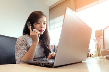 A woman is talking to someone on the phone.
