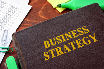 Book with title business strategy and financial data.