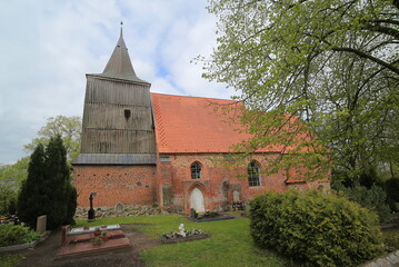 Fototapeta na wymiar Brick gothic church and cemetery in Hohendorf