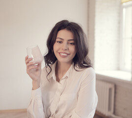 Young woman drinking yogurt