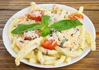 delicious delicious spaghetti with shrimps and basil on  plate
