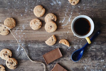 top view coffee cup with cookies and chocolate bar on wooden table texture 
