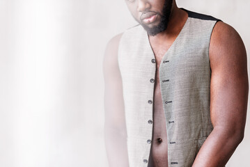 Serious sexy young guy demonstrating fashionable wear