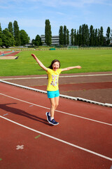 Obraz premium Little girl have fun on the stadium