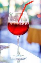 Spanish wine cold sangria drink in a glass with pieces of fruit and spices.