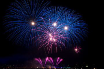 Fototapeta na wymiar Fireworks display on dark sky background.