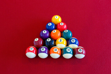 Colorful pool balls on a red table