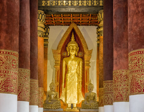 Golden statue of Buddha at temple in Wiang Sa, Nan, Thailand.  Wat Boon Yuen is a one of famous place to travel in northern. Selective focus at Buddha image while low light in temple hall.