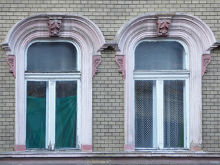 Two windows with green curtain