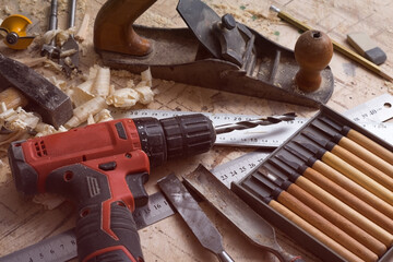 Various tools for carpentry on the table. Screwdriver, ruler, chisel on a wooden surface.