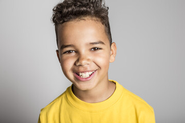 Adorable african boy on studio gray background