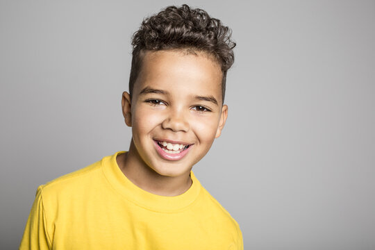 Adorable african boy on studio gray background