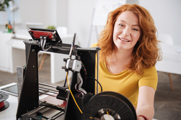 Positive happy woman working with 3d printing technologies