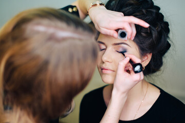 stylist working in a beauty salon and a nice lady