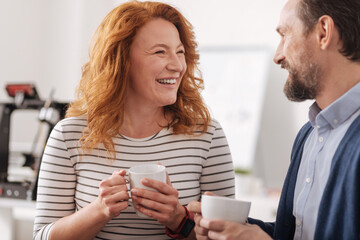 Delighted positive woman laughing