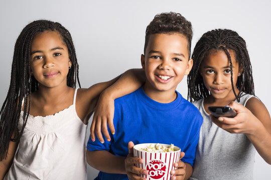 Black Little Boy And Sister Girl Watching Movie With Pop Corn