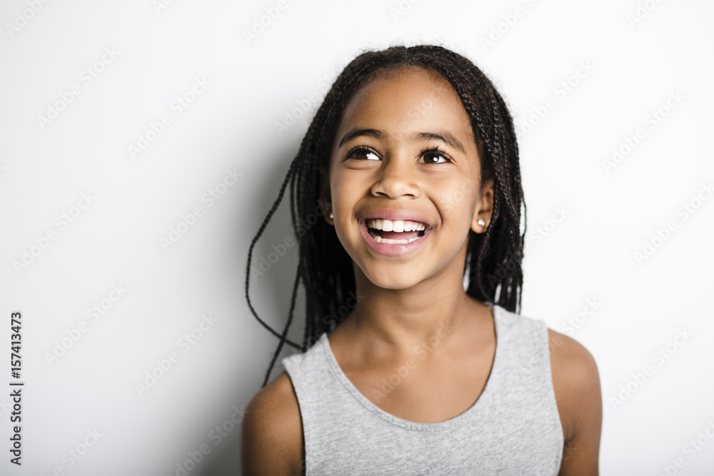 Wall mural Adorable african little girl on studio gray background