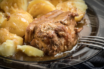 Stewed pork meat served with potatoes