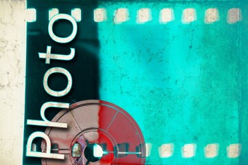 Vintage blue film strip frame with coil and "photo" word.