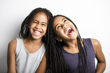 Adorable african twin little girls on studio gray background - obrazy, fototapety, plakaty