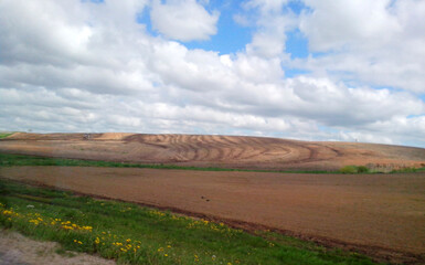 Fototapeta premium Beautiful plowed field near the road, landscape, nature, agriculture 