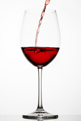Red wine splashes in a glass