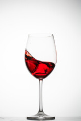 Red wine splashes in a glass