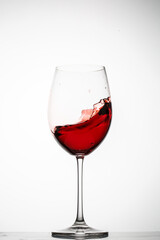 Red wine splashes in a glass