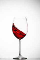 Red wine splashes in a glass
