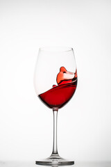 Red wine splashes in a glass