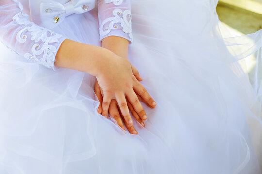 Child hands white dress