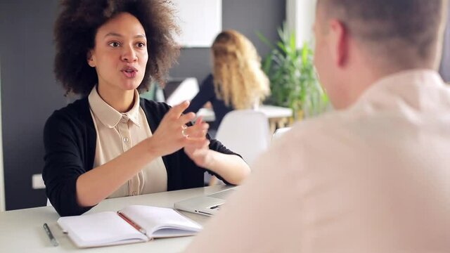 Young woman is talking to her male client