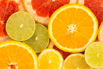 Fototapeta na wymiar Four slices of citrus fruits, closeup background.