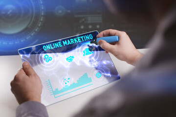 Business, Technology, Internet and network concept. Young businessman working on a virtual screen of the future and sees the inscription: Online marketing