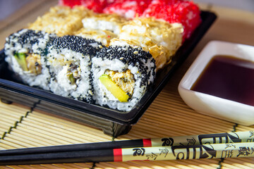 a plate of sushi pieces standing on a bamboo napkin 