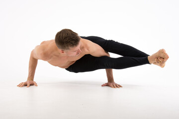 Fototapeta na wymiar Yoga. Sexy man and a healthy lifestyle. Sport and strength. 
