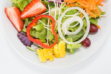 Fresh healthy salad dish with wooden spoon and fork. Isolated on white background
