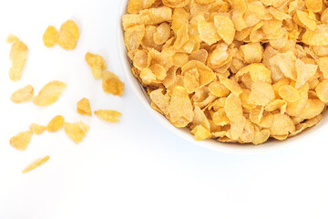 Cornflakes in porcelain bowl isolated on white background